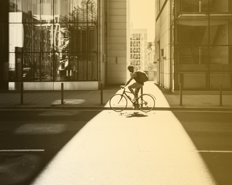 Photo of a person riding a bike in town
