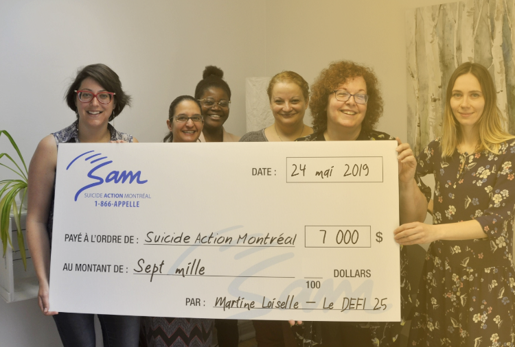 Photo of people holding an oversized cheque